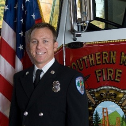 man next to fire truck